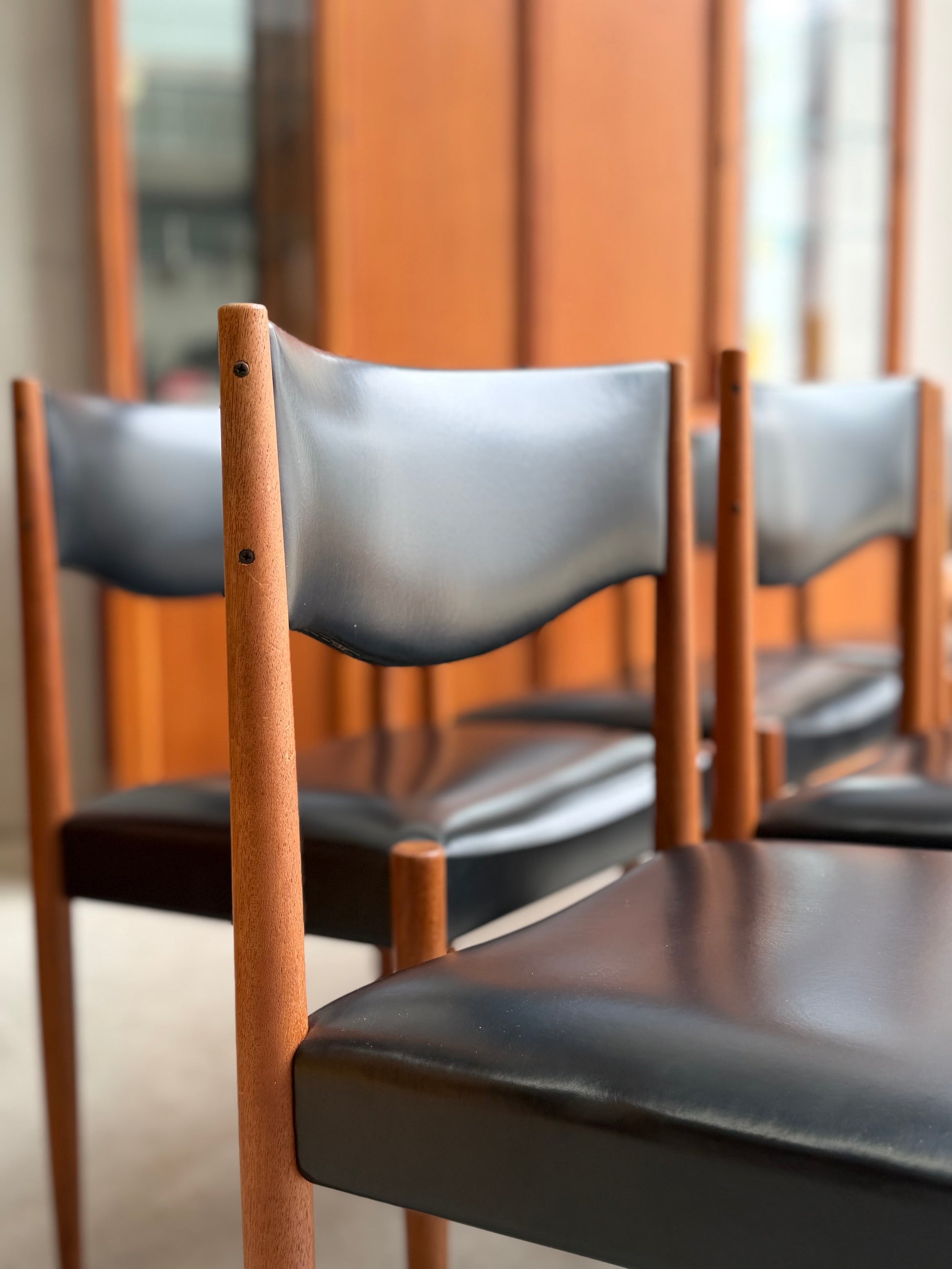 close-up of Parker Number 62 dining chair highlighting the minimalist mid-century modern backrest and warm teak tones
