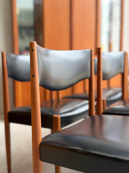 close-up of Parker Number 62 dining chair highlighting the minimalist mid-century modern backrest and warm teak tones