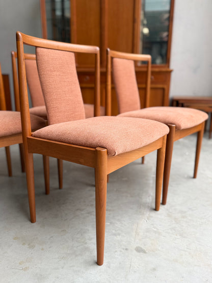 Two Parker 88 T Back Chairs with light brown upholstered seats are side by side on a concrete floor, wooden cabinets behind. Pre-order professional restoration for a set of 4 chairs with a 25% non-refundable deposit.