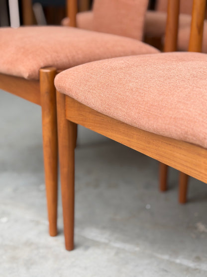 Close-up of fully restored Parker T-Back Number 88 Dining Chairs in terracotta upholstery, set of 4, showcased on a concrete floor.