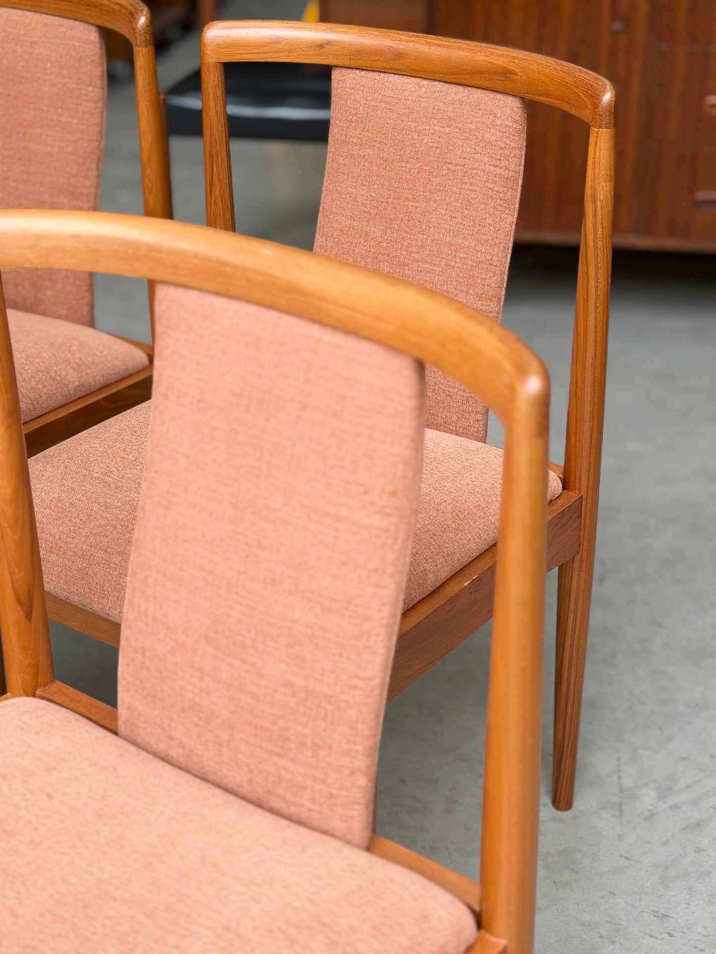 A set of four fully restored Parker T-Back Number 88 dining chairs in terracotta upholstery—classic mid-century modern design elevated by Rediscover.