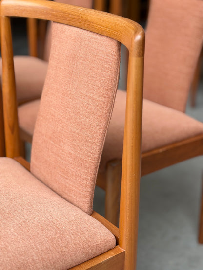 Close-up of two Parker 88 T Back Chairs, professionally restored with light brown upholstery and smooth curved wooden frames. Shown on a gray floor. Pre-order set of 4 with a 25% non-refundable deposit required.
