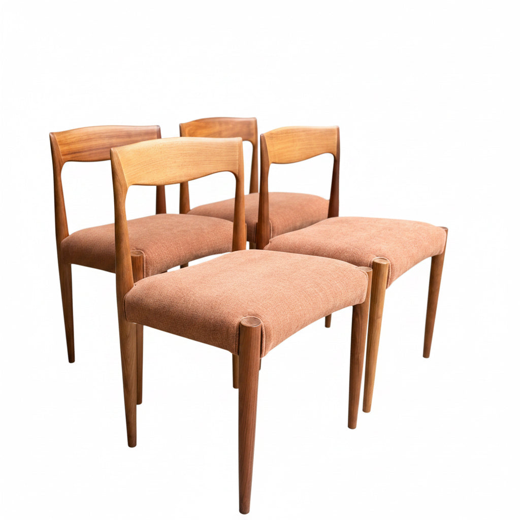 The Fully Restored THB 'Milan' Dining Chairs Set of 4 (Rediscover) are Australian mid-century pieces made from Tasmanian blackwood, each with light brown upholstered seats, shown on a concrete floor amid wooden furniture.