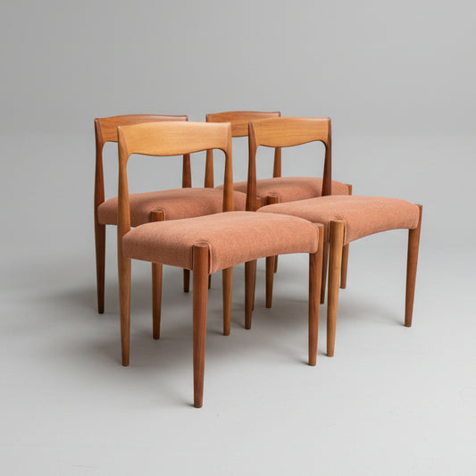 A set of four fully restored THB 'Milan' dining chairs (Rediscover) are grouped together on a plain light gray background, showcasing their curved backs and light reddish-brown upholstered seats.