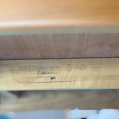 Close-up of the underside of a Fler 64 Rectangular extension Table (Refine), highlighting the upside-down, partially blurred manufacturer’s stamp on its wooden support beam and emphasizing its vintage Australian design against a blurred background.