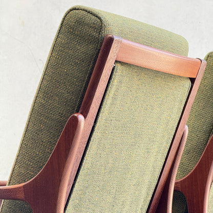 Close-up of the backrests of two Don Rex Armchair - Green Forest (Rediscover), highlighting mid-century Australian design with green upholstery and wooden frames, set against a light gray background.