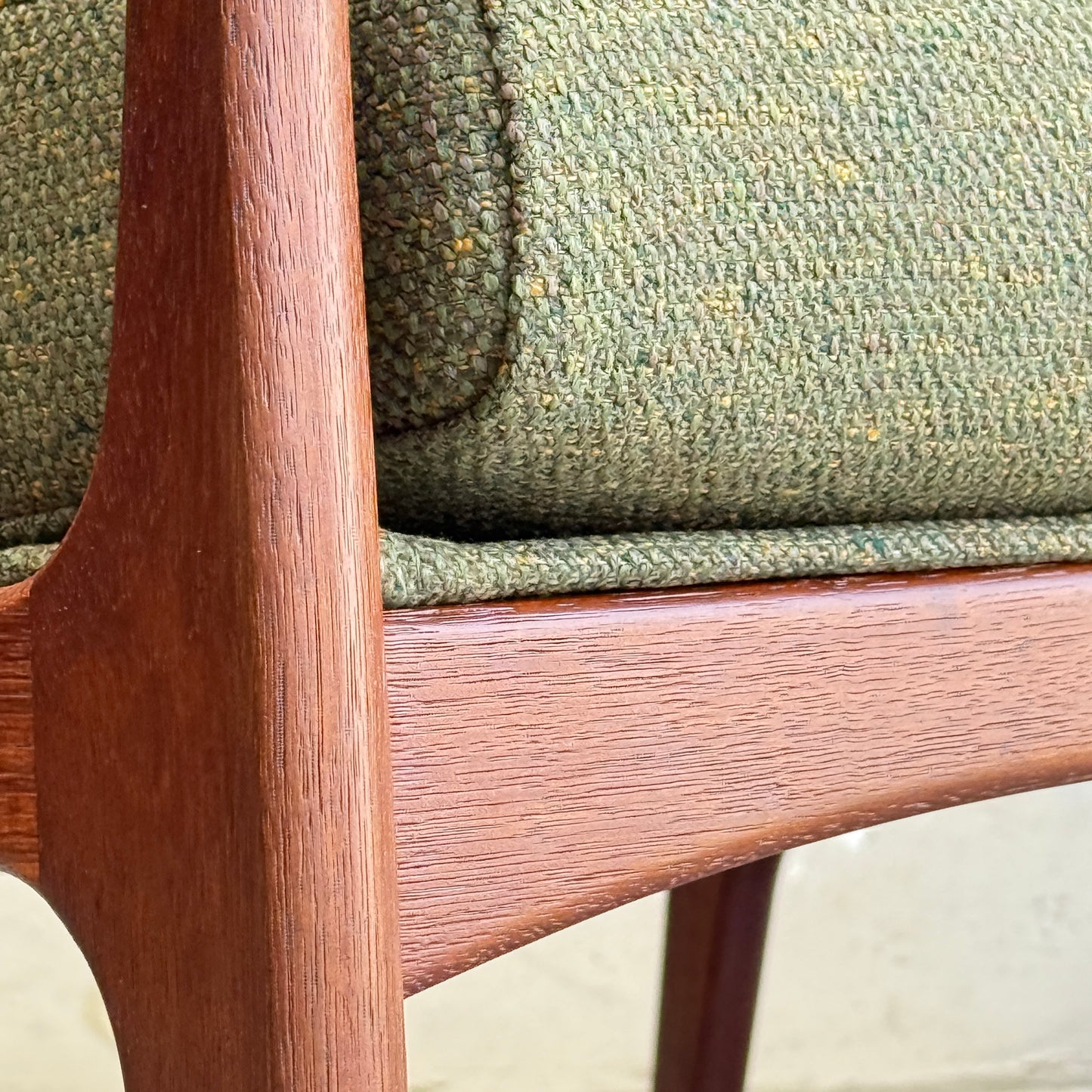 Close-up of the Don Rex Armchair - Green Forest (Rediscover) featuring a smooth, reddish wood frame and green textured speckled upholstery, showcasing classic mid-century Australian furniture style.
