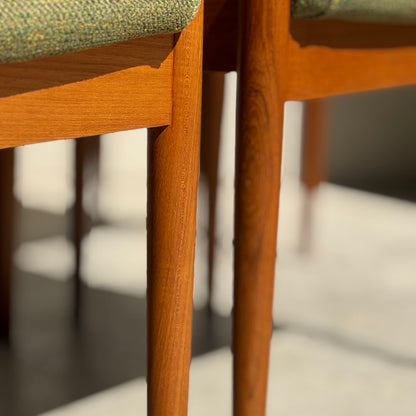 Close-up of the fully restored Parker T-Back Number 88 Dining Chairs Set of 4 - Forest Green (Rediscover), showcasing elegant wooden legs, green upholstery, and mid-century modern design in sunlight with soft floor shadows.