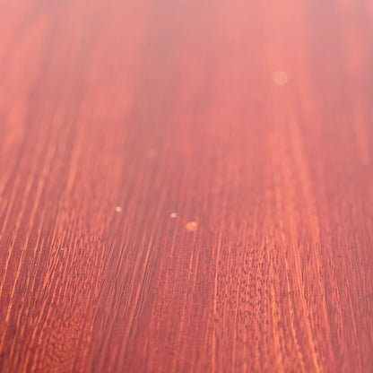 Close-up of the smooth, reddish-brown solid wood surface of the Joe Rufenacht Designer Round Dining Table—a rare mid-century gem—showcasing elegant grain and subtle texture that evoke refined craftsmanship.