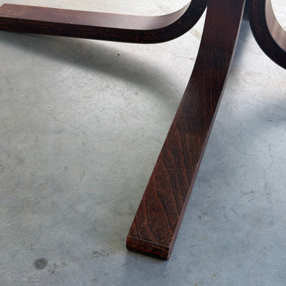 Close-up of dark wooden legs from the Signature Vintage Ingmar Relling Siesta Set—two lounge chairs and a rare coffee table—resting on a textured gray concrete floor.