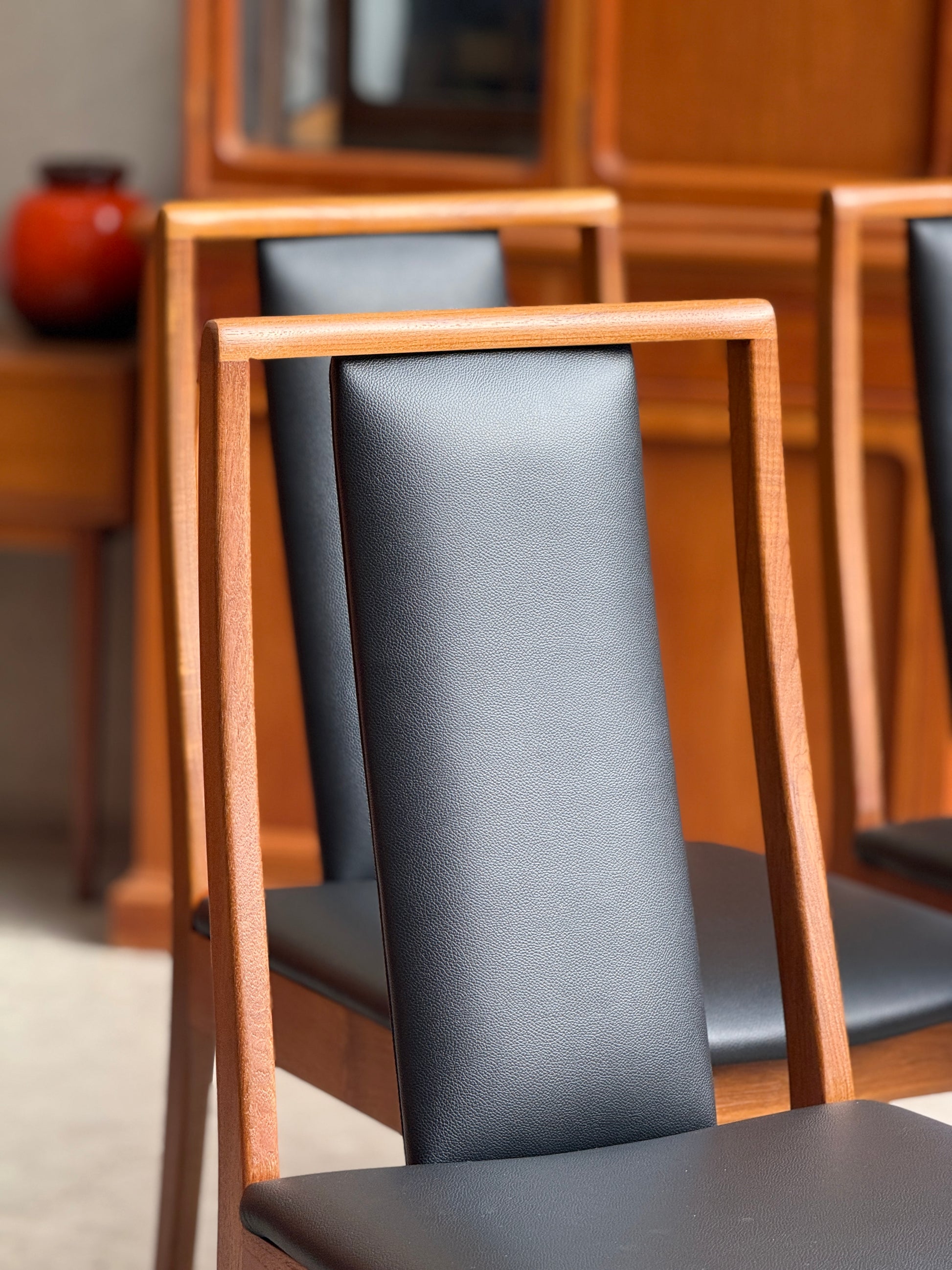 Close Up of Restored Noblett Boston T-back mid-century modern dining chairs showing open ladder back design and teak
