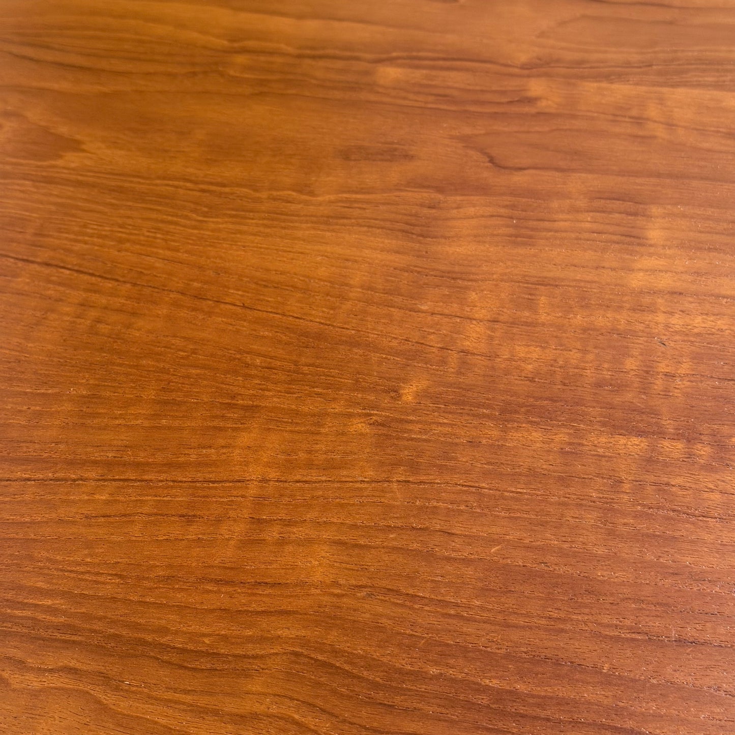 A close-up of the Fully Restored Parker No.91 Fixed Top Oval Table (Rediscover), featuring a smooth finish, distinctive natural grain, and warm brown tones evocative of classic mid-century design.