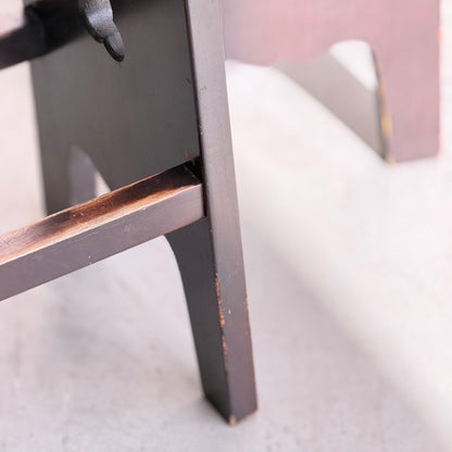 Close-up of the lower legs of a dark wooden stool on a light floor, showing worn edges and scratches—classic character seen in 1970s Australian Mid-Century Modern Spanish Revival Davis Stools – Set of 3 (Revive).