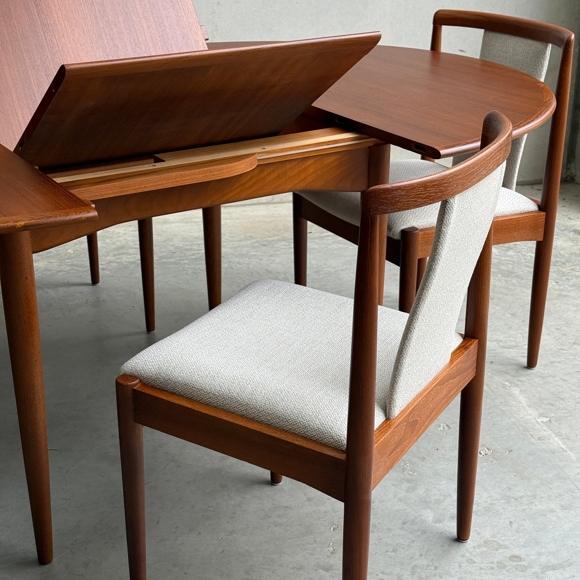 Fully restored Parker 90 round extension butterfly table (table only, Rediscover) showcased on a concrete floor.