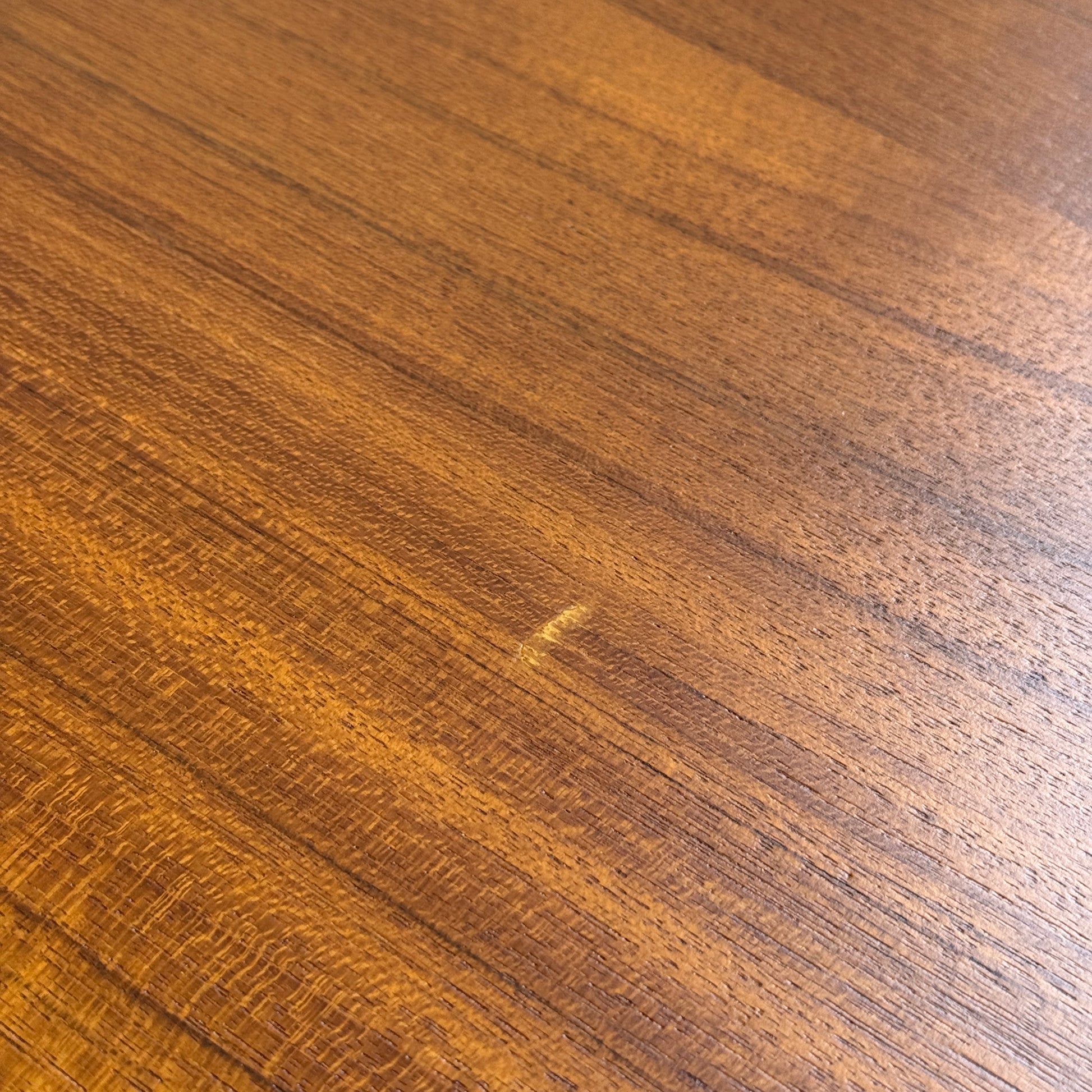 A close-up of the Fully Restored Parker Dining Suite 5 Piece Square - Number 140 (Rediscover) shows its warm brown finish and wood grain, with a small light scratch near the center on the tabletop.
