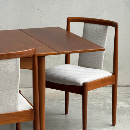 A Fully Restored Parker Dining Suite 5 Piece Square - Number 140 (Rediscover) is showcased, featuring a mid-century modern teak table with extension leaf and matching chairs, all set on a concrete floor against a plain light gray wall.