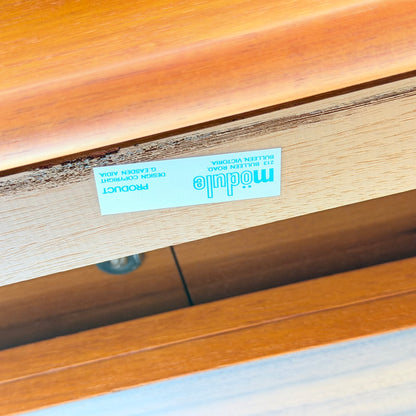 A close-up of a wooden drawer, likely from the Rare Gerald Easden Rectangular Extension Dining Table (Rediscover), shows an upside-down blue and white label reading module, 213 Bullenden Road, Bulli NSW, with partial copyright info inside.