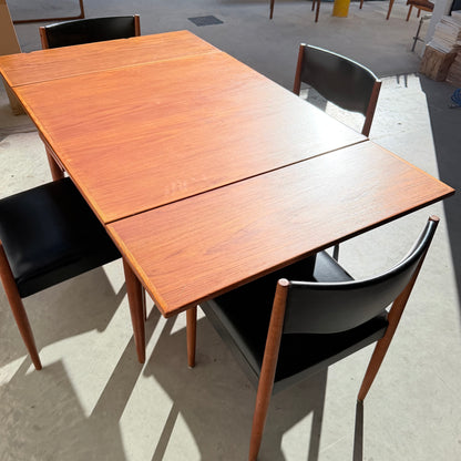 The Vintage Parker Dining Suite 5 Piece Square - Number 140 (Refine) features a sleek wooden table and four matching chairs, bathed in sunlight that highlights the Scandinavian-inspired Australian design and concrete floor.