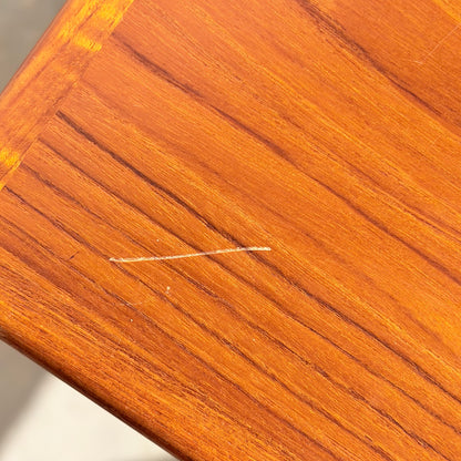 A close-up of the Vintage Parker Dining Suite 5 Piece Square - Number 140 shows a polished wood surface with a light-colored scratch running diagonally near the corner along the grain.