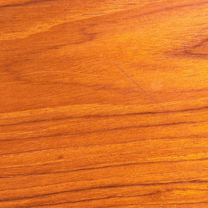 Close-up of a smooth, polished wooden surface with rich natural grain in warm brown and gold hues—echoing Scandinavian-inspired Australian design as seen in the Vintage Parker Dining Suite 5 Piece Square - Number 140 (Refine). Elegant color variation is highlighted.