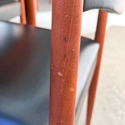 Close-up of a Vintage Parker Dining Suite 5 Piece Square - Number 140 chair leg showing minor scratches beside black upholstery, highlighting authentic mid-century Australian design with a softly blurred background.