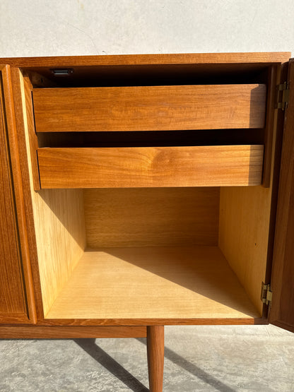 A restored Iconic Parker Teak 4-Door Sideboard (Rediscover) with tapered legs, sunlight highlighting its Australian craftsmanship, elegant wood grain, open to reveal spacious compartments and upper drawers in true mid-century modern style.