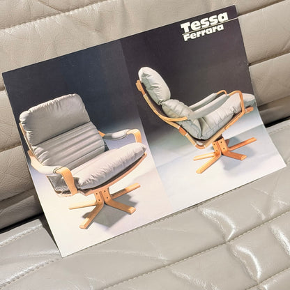 A brochure showcases two Tessa Ferrara Swivel Armchairs (Revive) with light wood frames and plush gray cushions, inspired by mid-century Australian design, set against a tufted gray leather background.