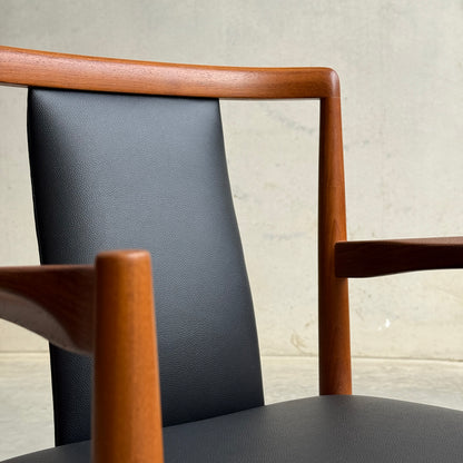 Close-up of the Pre-Order: Professional Restoration of Parker 89 Chair, featuring a wooden frame and black commercial-grade vinyl upholstery on the backrest and seat; 25% non-refundable deposit required.