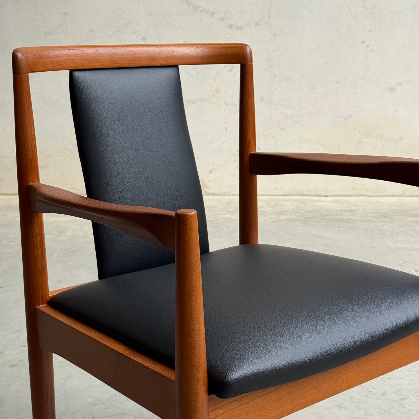 A Pre-Order: Professional Restoration of Parker 89 Chair (25% non-refundable deposit) is shown featuring a sleek black commercial-grade vinyl seat and backrest, minimalist design, and clean lines against a plain light background.