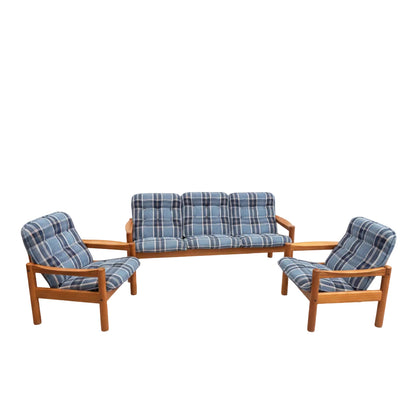 The Vintage Domino Møbler Sofa & Pair of Armchairs – Blue Plaid Mid-Century Set COMING SOON: a Danish Modern suite with a three-seater sofa and two matching armchairs, all wooden-framed with blue plaid cushions on a plain gray background.