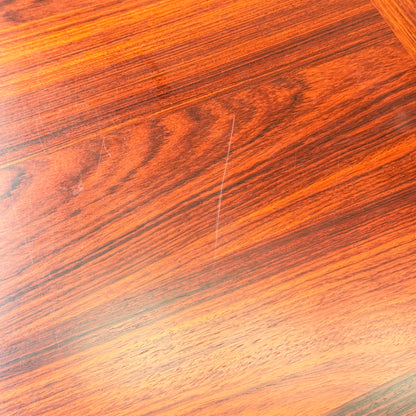 Close-up of a polished, reddish-brown rosewood surface from the 1970s Danish Modern Rosewood Dropleaf Dining Table (Model 166, 1975) by Vejle Stole og Mobelfabrik, highlighting its visible grain and classic mid-century glossy finish.