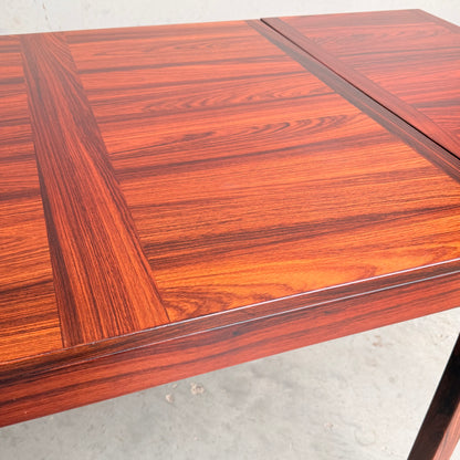 Close-up of a 1970s Danish Modern Rosewood Dropleaf Dining Table by Vejle Stole og Mobelfabrik (Model 166, 1975), highlighting its rich wood grain and mid-century design, set against a light background.