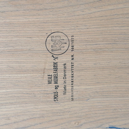 Close-up of a wooden surface stamped with "Vejle Stole og Mobelfabrik, Made in Denmark"—the hallmark found on this 1970s Danish Modern Rosewood Dropleaf Dining Table (Model 166, 1975).