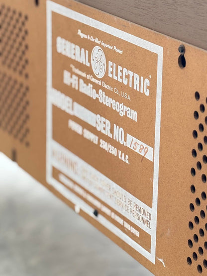 Close-up of a label on the General Electric Credenza - Spacemaker 250 Fully Converted Teak TV / Entertainment Console, showing model and serial number fields with "15892" handwritten in red ink under SER. NO. on the back panel.