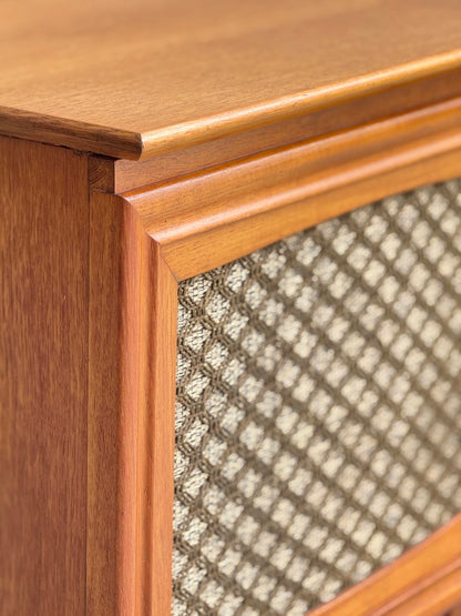 Close-up of the General Electric Credenza - Spacemaker 250, a fully converted teak TV/entertainment console featuring a book-matched cabinet corner and decorative diamond-patterned fabric grille, all in a warm, polished mid-century modern finish.